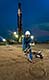Setting up wire lining tools at night on oil exploration site, Uganda